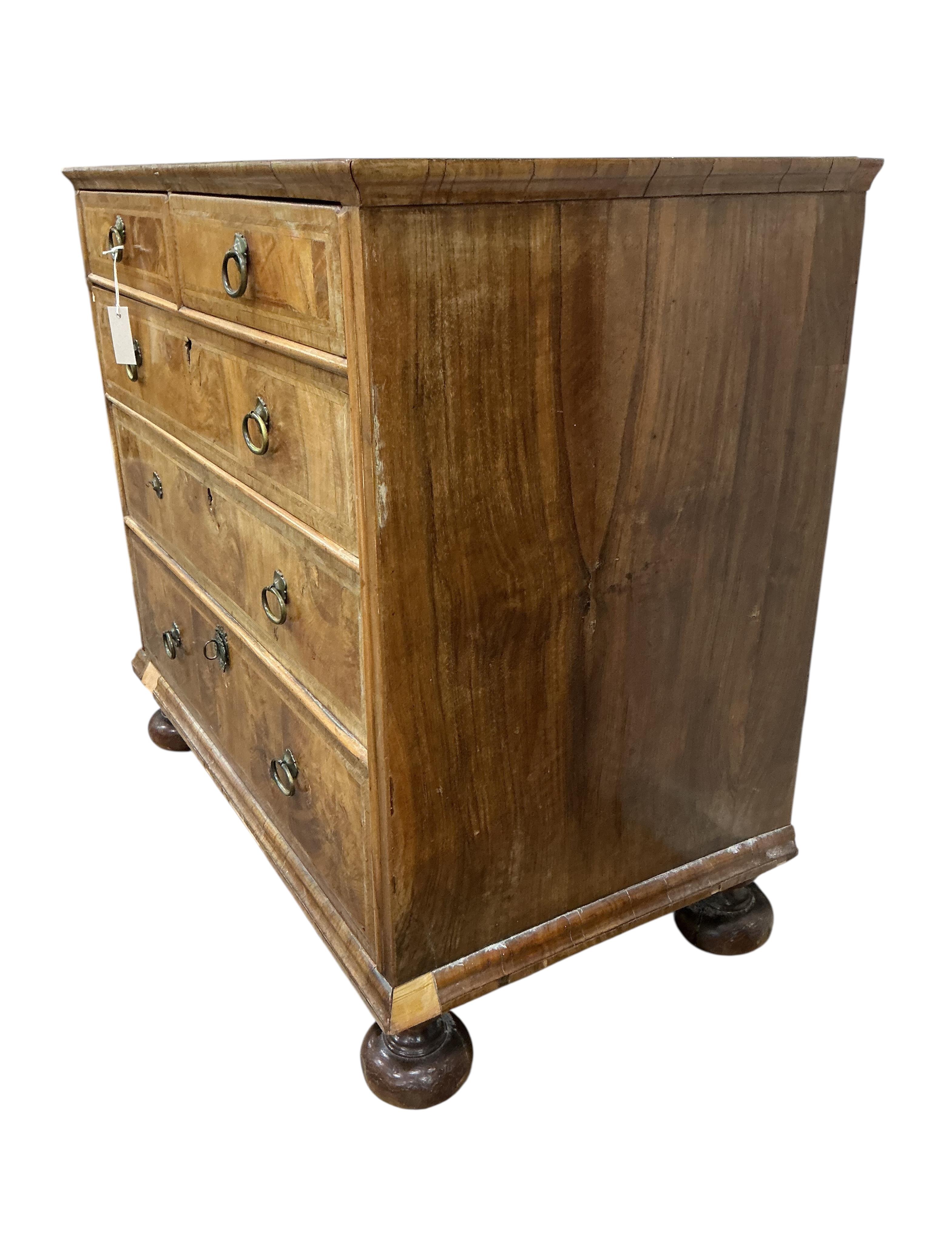 An early 18th century feather banded walnut chest, damaged, width 95cm, depth 54cm, height 91cm